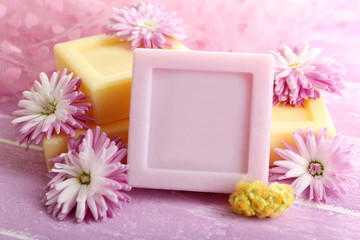 Obraz na płótnie Canvas Bars of natural soap and fresh flowers