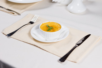 Bowl of pumpkin soup served at table