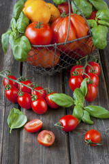 Fresh colorful delicious tomatoes on a old wooden table