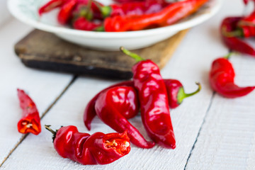 the broken chili peppers on a white background