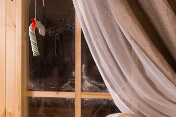 Christmas candy cane hanging in a window