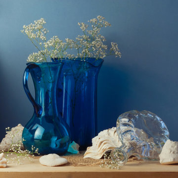 Still life with blue glass vases and seashells