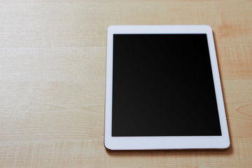 From view of a tablet pc sitting on a wooden desk