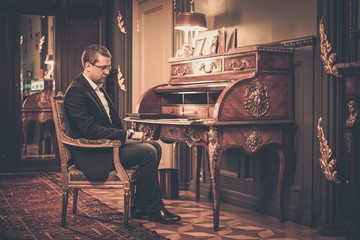 Sad middle-aged man in luxury vintage style interior