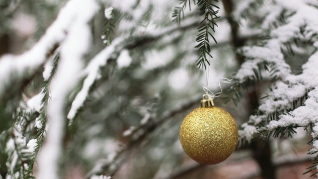 Christmas tree in snow and yellow globe