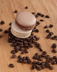 Chocolate and vanilla macaroon on the coffee beans 