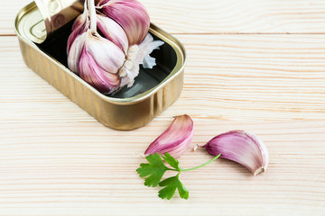 Garlic and parsley in tin can with carrots