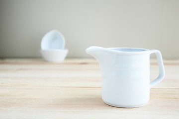 Square white cup over wooden table