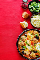 meatballs with olives and egg in tomato sauce