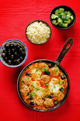 meatballs with olives and egg in tomato sauce