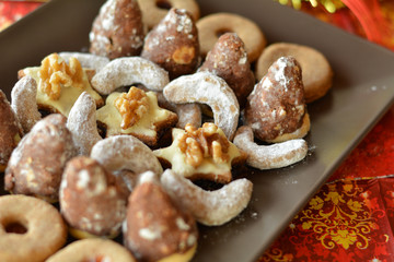 Various Christmas Cookies On The Brown Plate