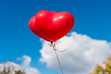 Fototapeta na wymiar Valentine heart balloon against blue sky background