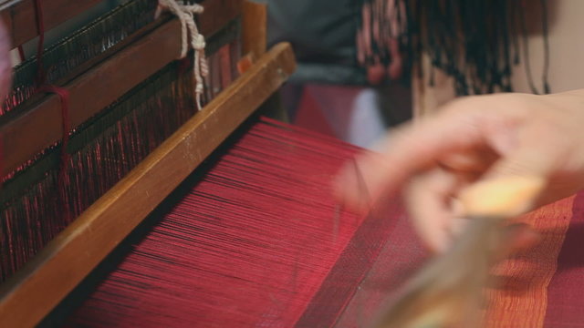 Weaver working on the loom