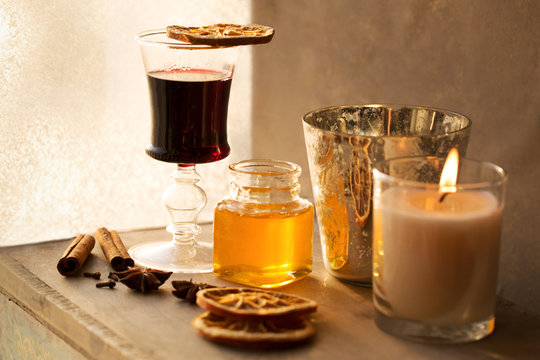 Mulled wine and spices on wooden background