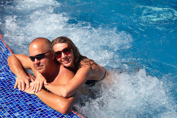 Loving couple in jacuzzi.