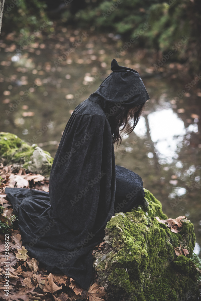 Wall mural beautiful dark vampire woman with black mantle and hood