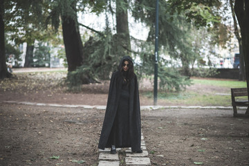 beautiful dark vampire woman with black mantle and hood