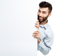 A young bearded man showing blank signboard, isolated over white