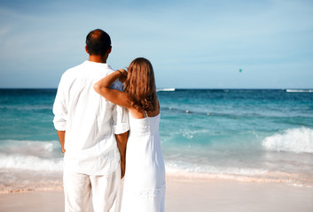 Loving couple looking the ocean