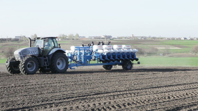 tractor leaving the field with a drill
