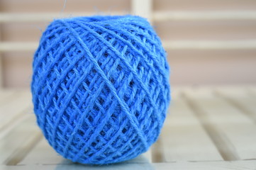 Blue yarn for crocheting on wooden table