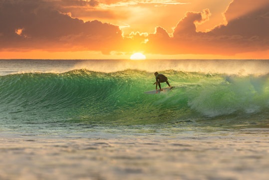 Surfer Surfing at Sunrise