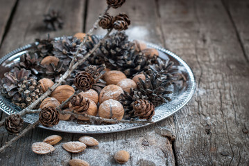 Christmas holiday decoration. Tray with Pine cones and Nuts