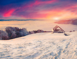 Colorful winter sunrise in the  fogyy mountains.