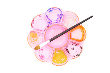 used pink palette and paintbrush  on white background, top view