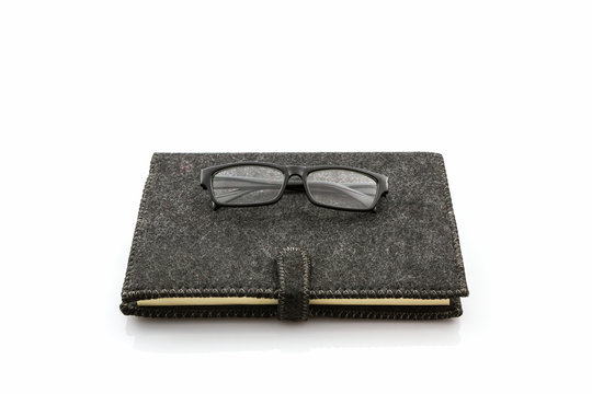 Black book with glasses .