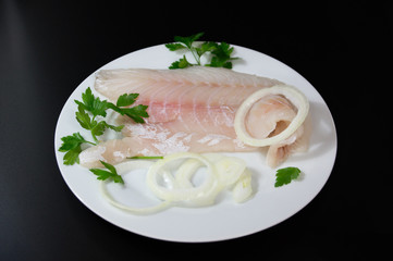 Fresh fish  with red scales   on white plate close up