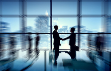 Group of business people discussing at city view reflected onto