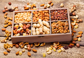 various dried nuts in wooden box