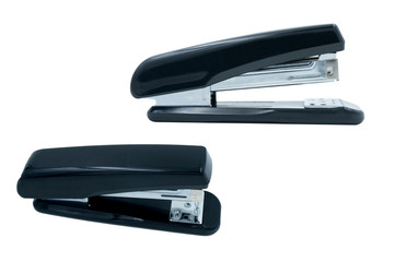 Two black staplers on white background