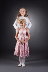 Image of beautiful little sisters posing in studio