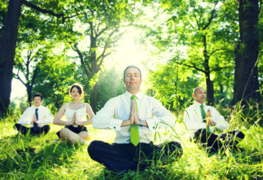 Business People Meditating In The Woods