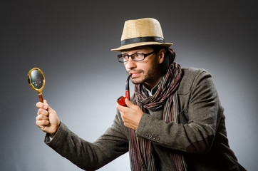 Funny detective with smoking pipe and magnifying glass