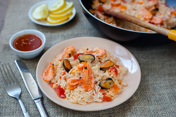 Spanish dish paella with seafood, shrimps in pan