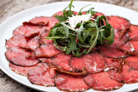 white dish with carpaccio of beef