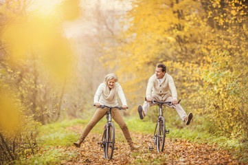 Active seniors ridding bike and having fun