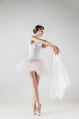 Naklejka premium Ballet dancer in white tutu posing