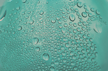close up shot of water drops on glass surface as background.