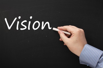 Writing the word Vision on a Blackboard