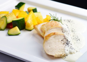 Grilled chicken breast with fresh vegetables . Selective focus