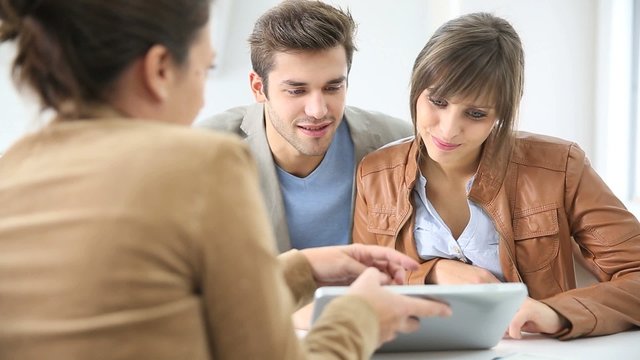 Young couple meeting real estate agent