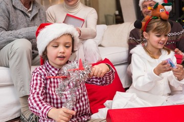 Festive little siblings opening gifts