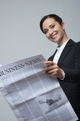 Businesswoman with financial newspaper