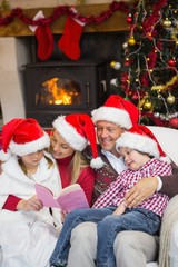 Fototapeta na wymiar Happy family reading at christmas
