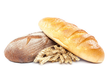 Bread and wheat ears on white background.