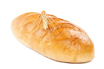 Bread loaf and wheat ear on white background.